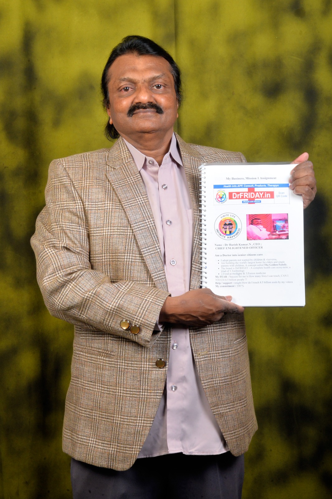 Dr. Harish Kumar holding his mission notebook